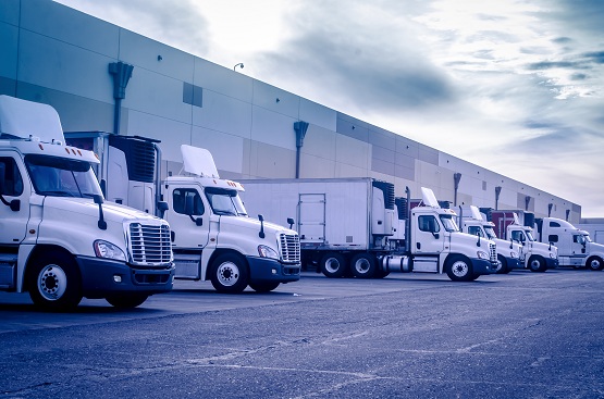 Trucks loading unloading at warehouse logistics transportation concept image